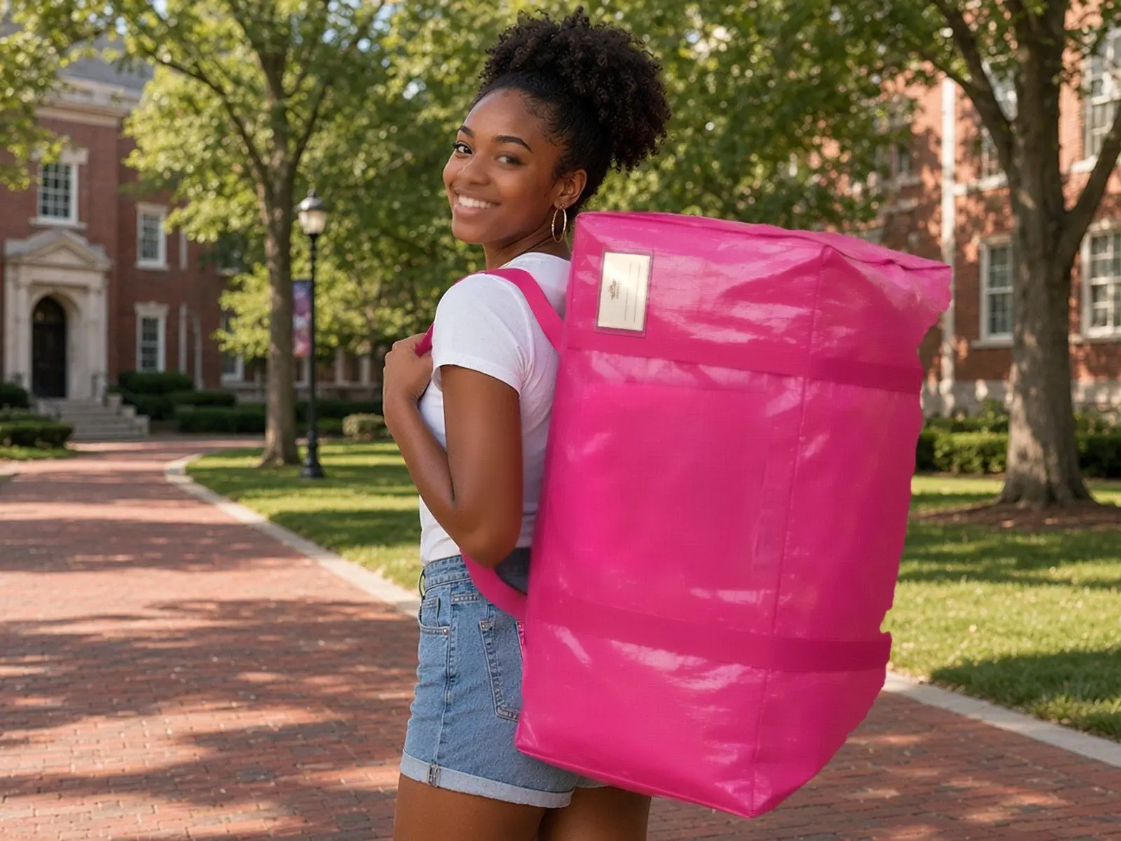 A woman wearing a Barbie pink CasaBella bag like a backpack on a campus